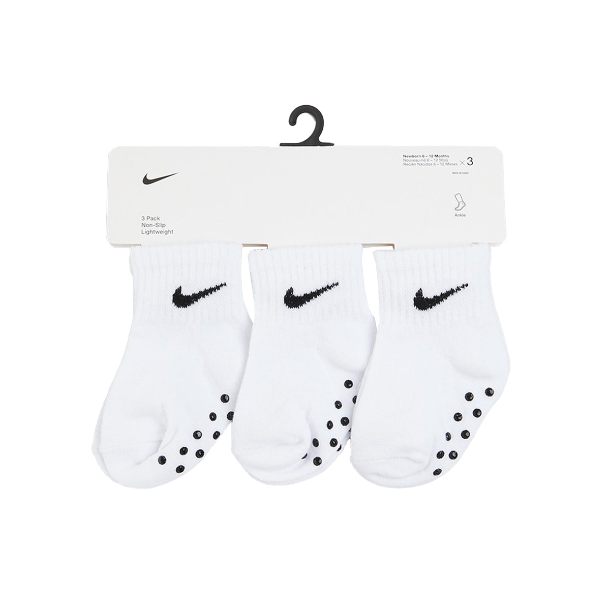 White and black Nike Core Swoosh gripper socks for infants with non-slip soles.